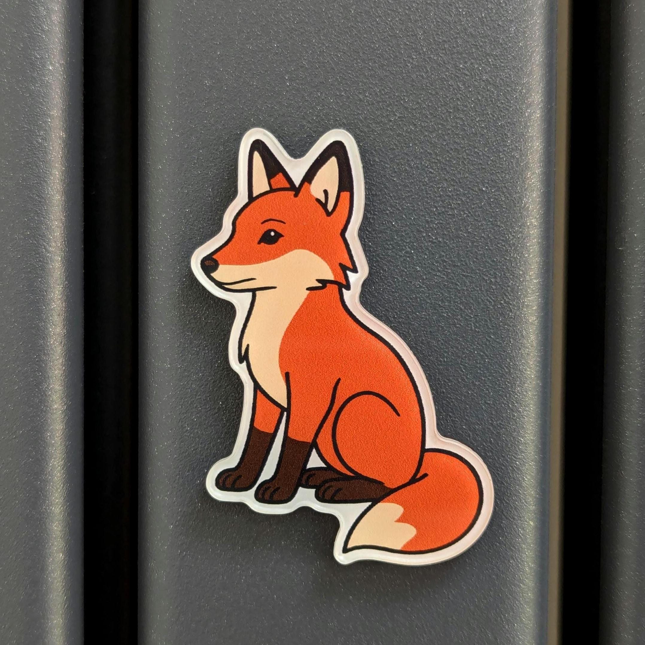 Fridge magnet of a fox on a dark surface