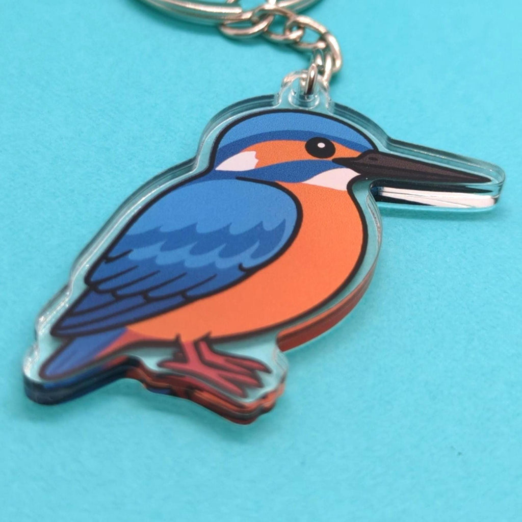 Keychain with a kingfisher bird design on a blue background