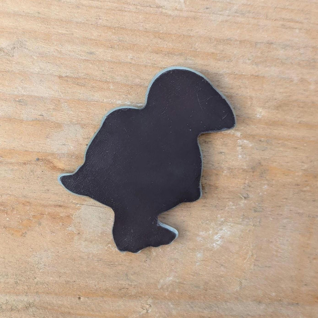 back of fridge magnet on a wooden surface