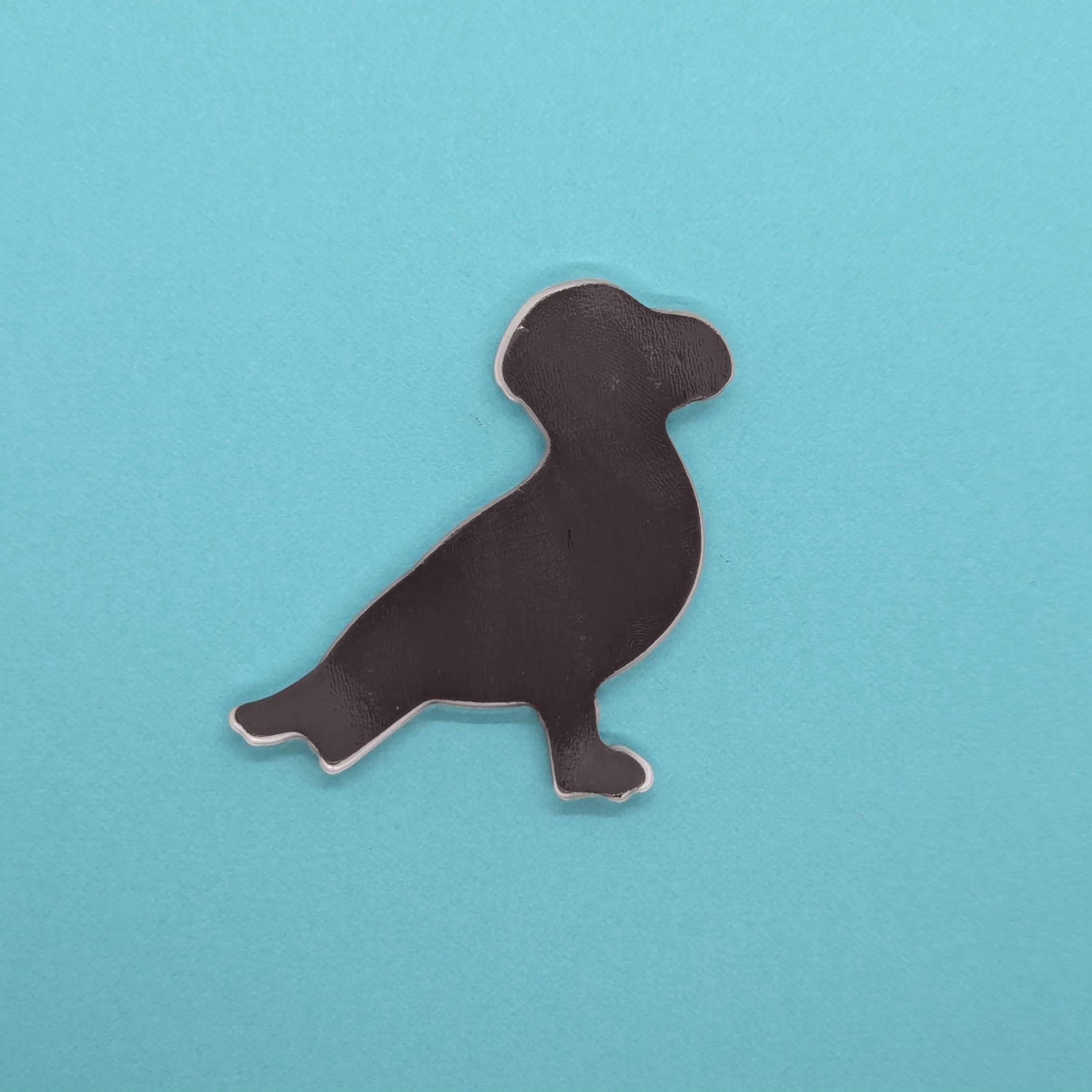 back of seagull fridge magnet on a blue background