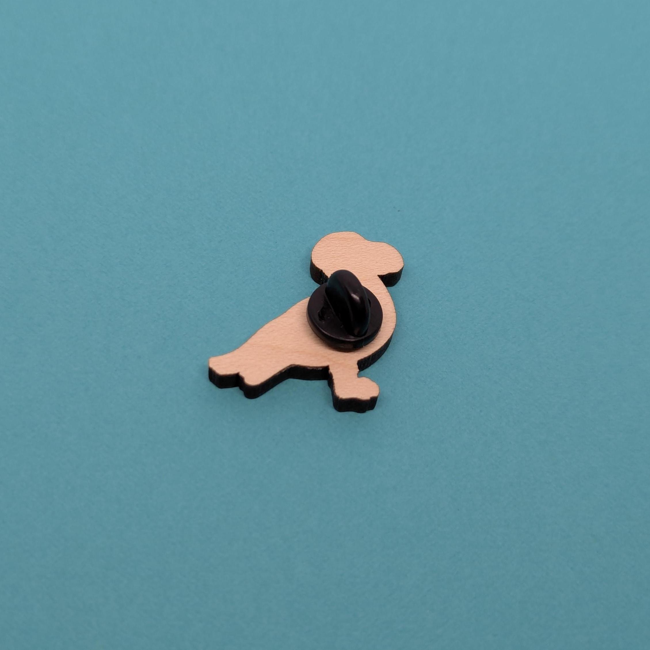 Back of seagull wooden pin badge on blue background