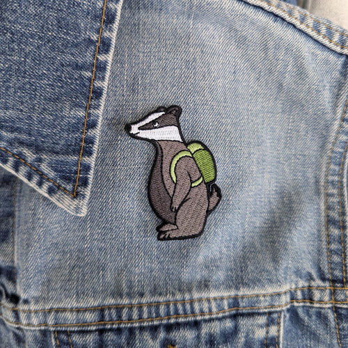 Embroidered badger patch on a denim jacket