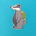 Cartoon badger with a green backpack on a blue background