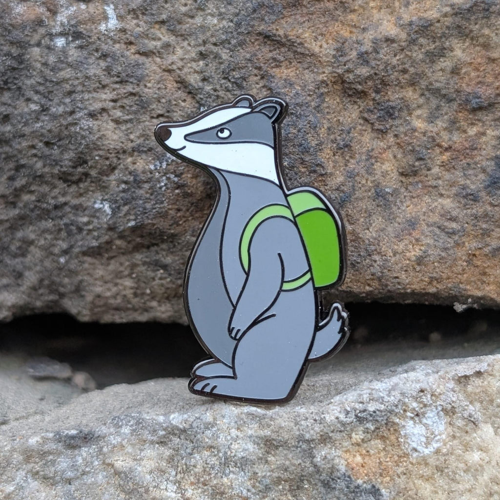 Badger with a green backpack on a stone background