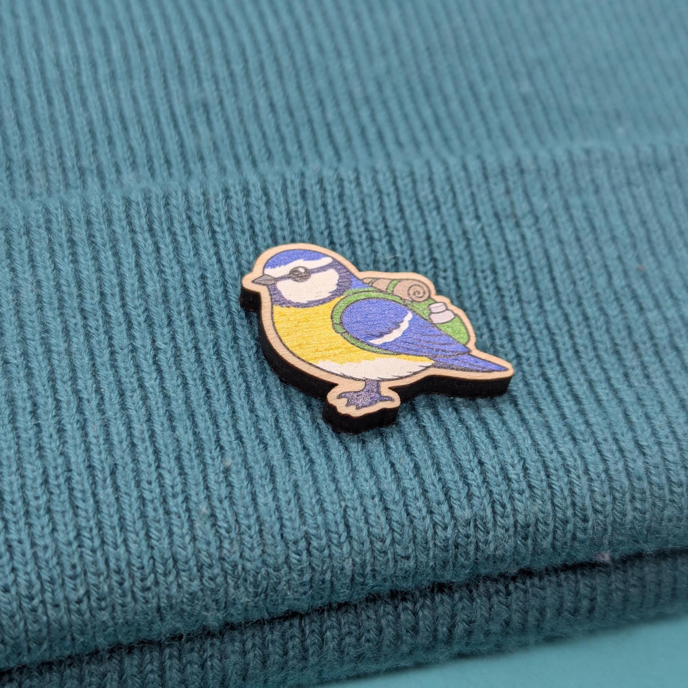 blue tit bird pin on a textured teal fabric background