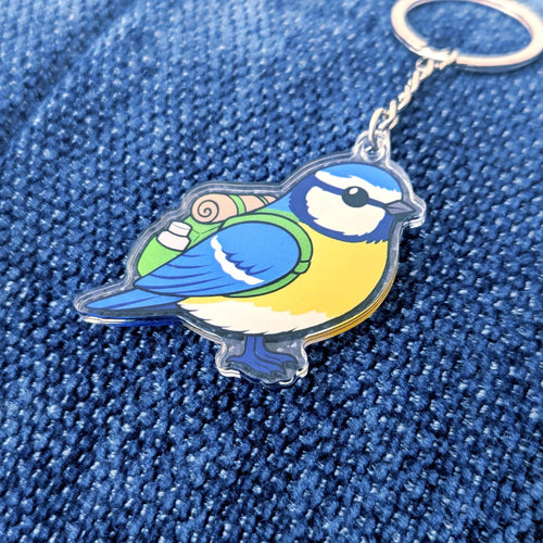 Blue tit bird keychain on a blue denim background