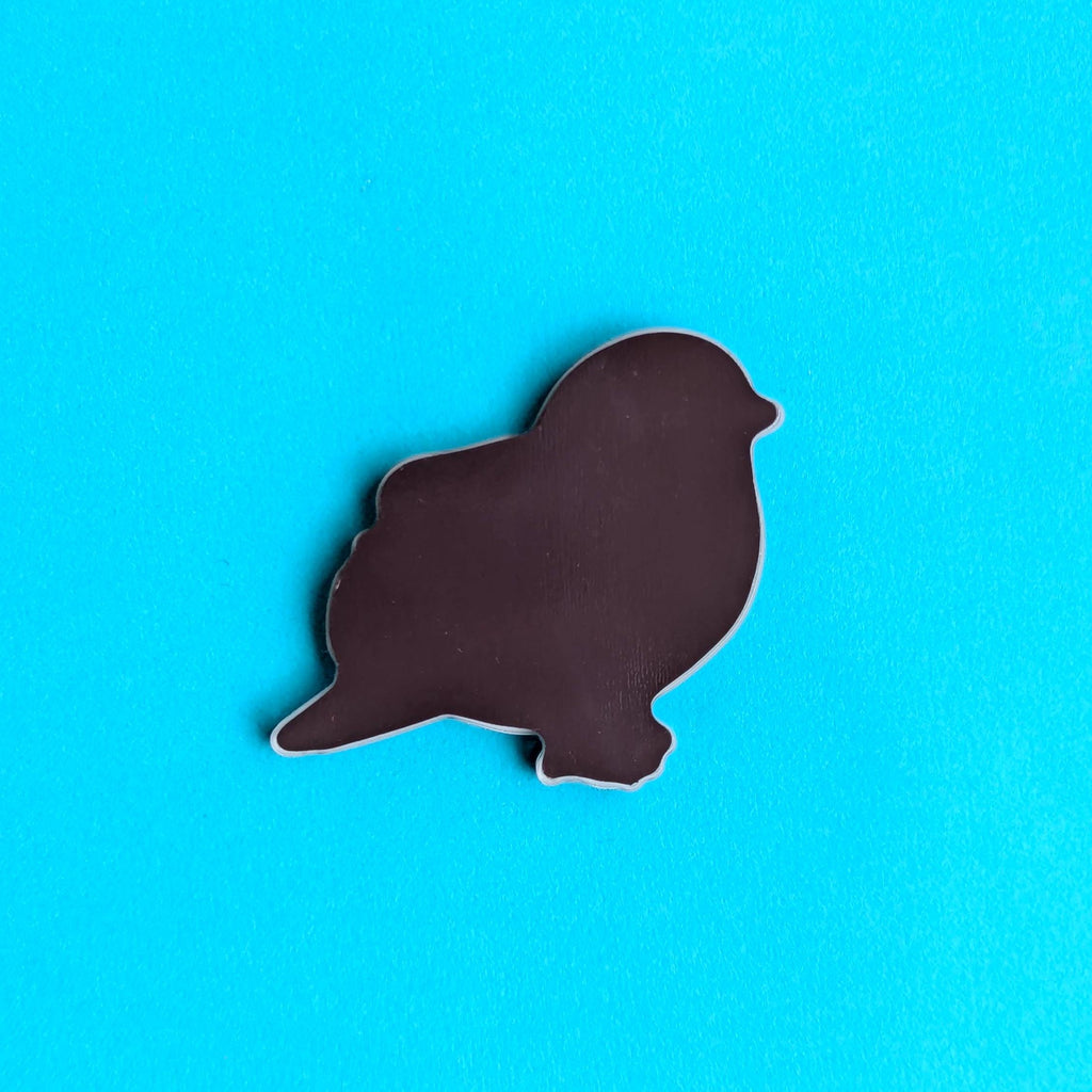 Back view of our blue tit magnet on a blue background
