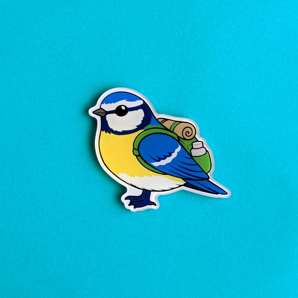 Blue tit bird fridge magnet with blue, yellow, and green colors on a blue background