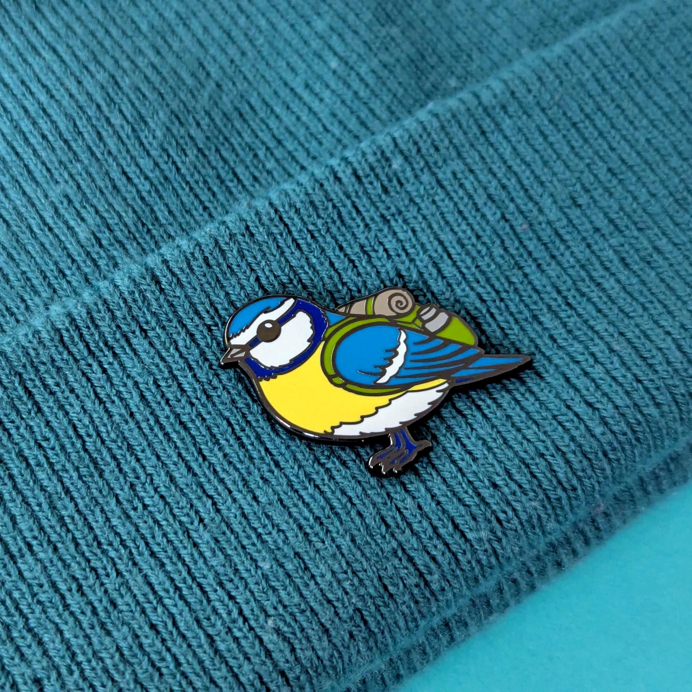 blue tit bird pin on a textured blue fabric background