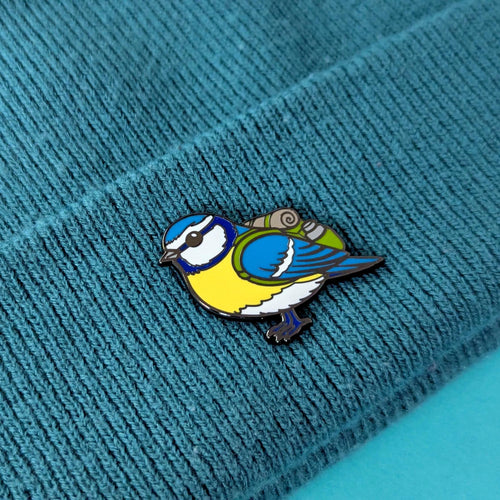 blue tit bird pin on a textured blue fabric background