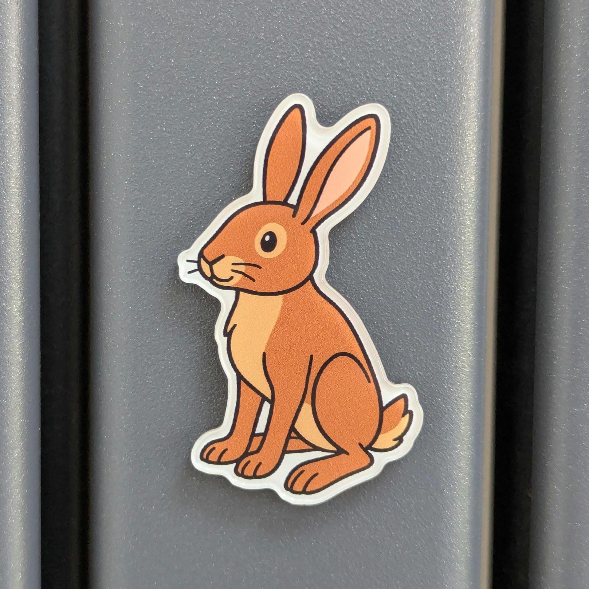 Fridge magnet of a rabbit on a metallic surface
