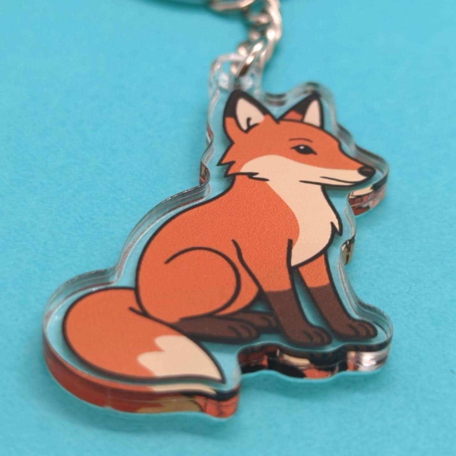 Fox keychain on a blue background