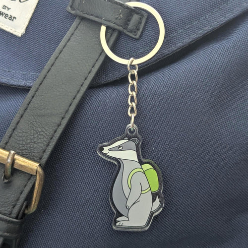 Keychain with a badger design on a blue bag
