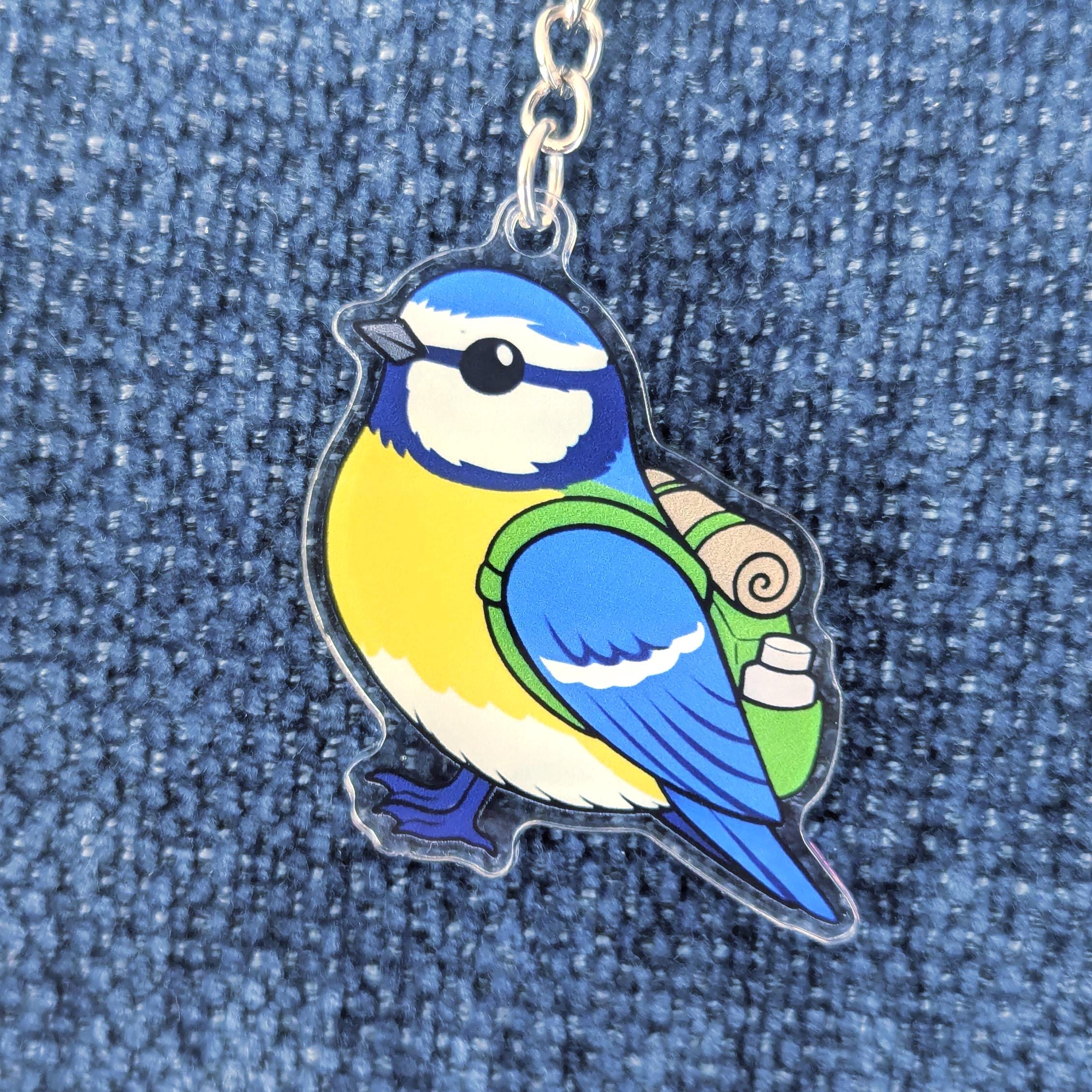 garden bird keychain on denim background