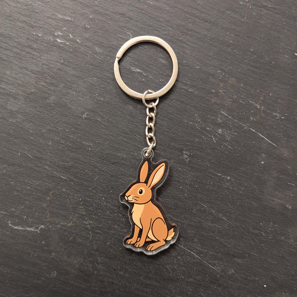 Keychain with a hare design on a dark surface