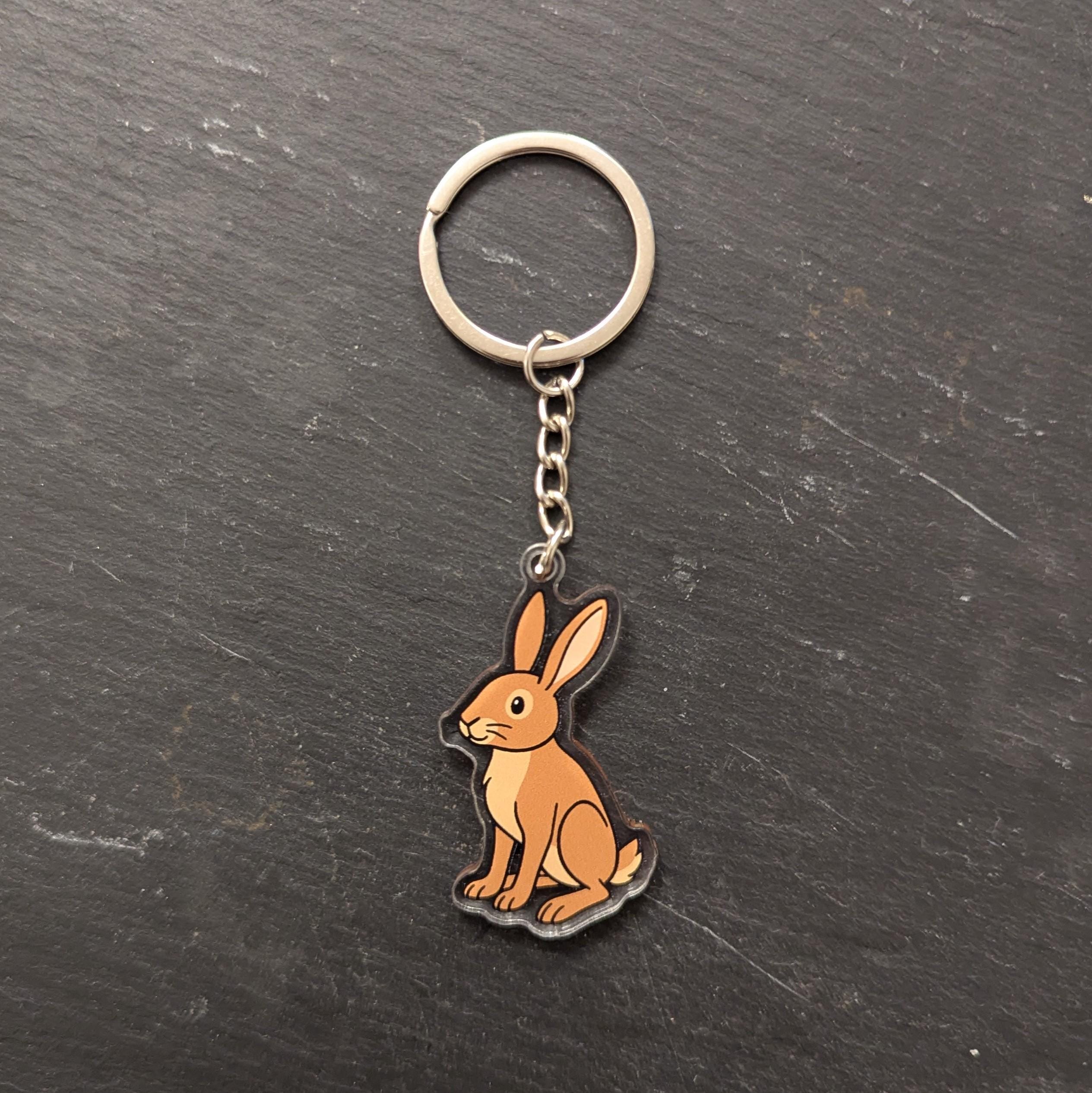 Keychain with a hare design on a dark surface