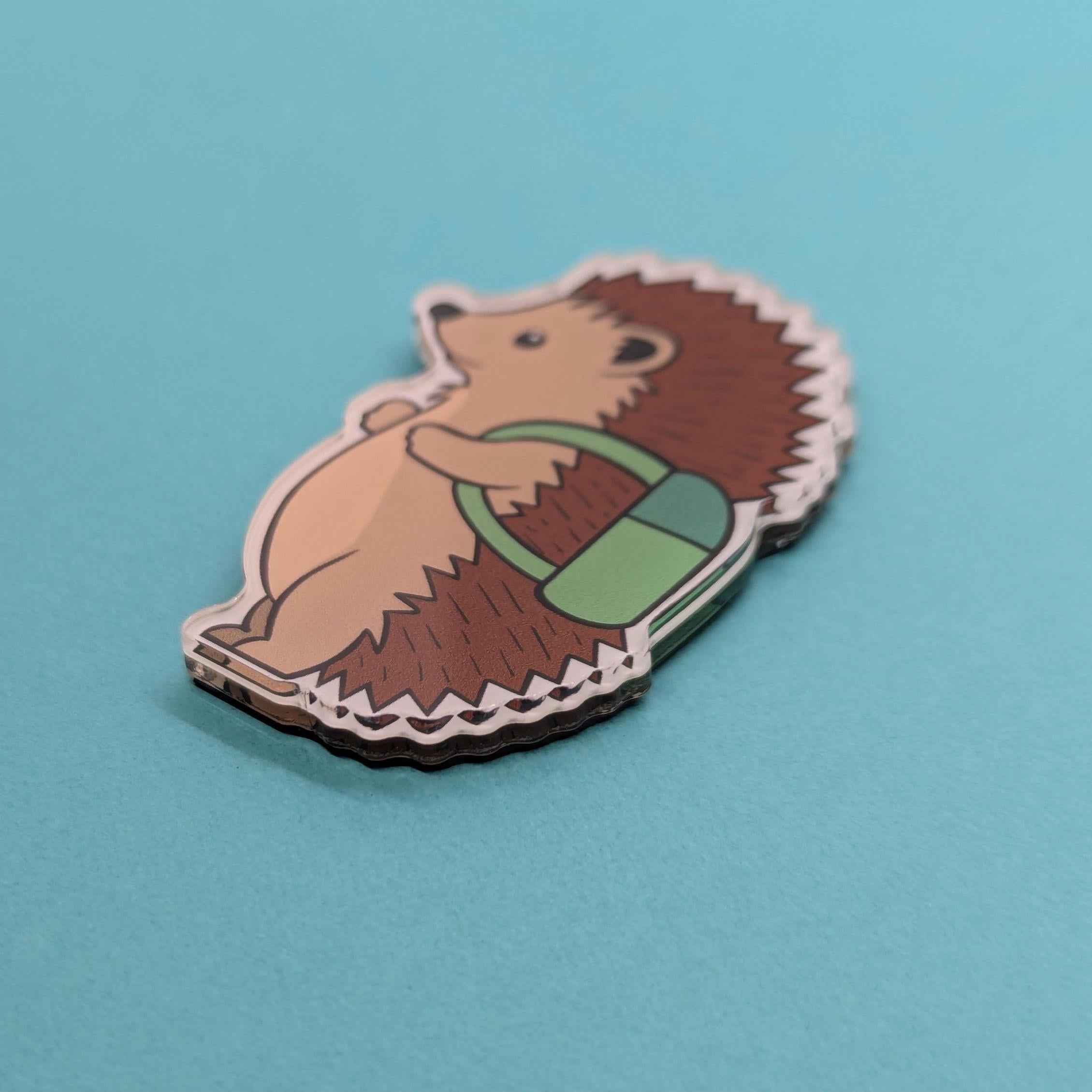 Hedgehog-shaped card with a green scarf on a blue background