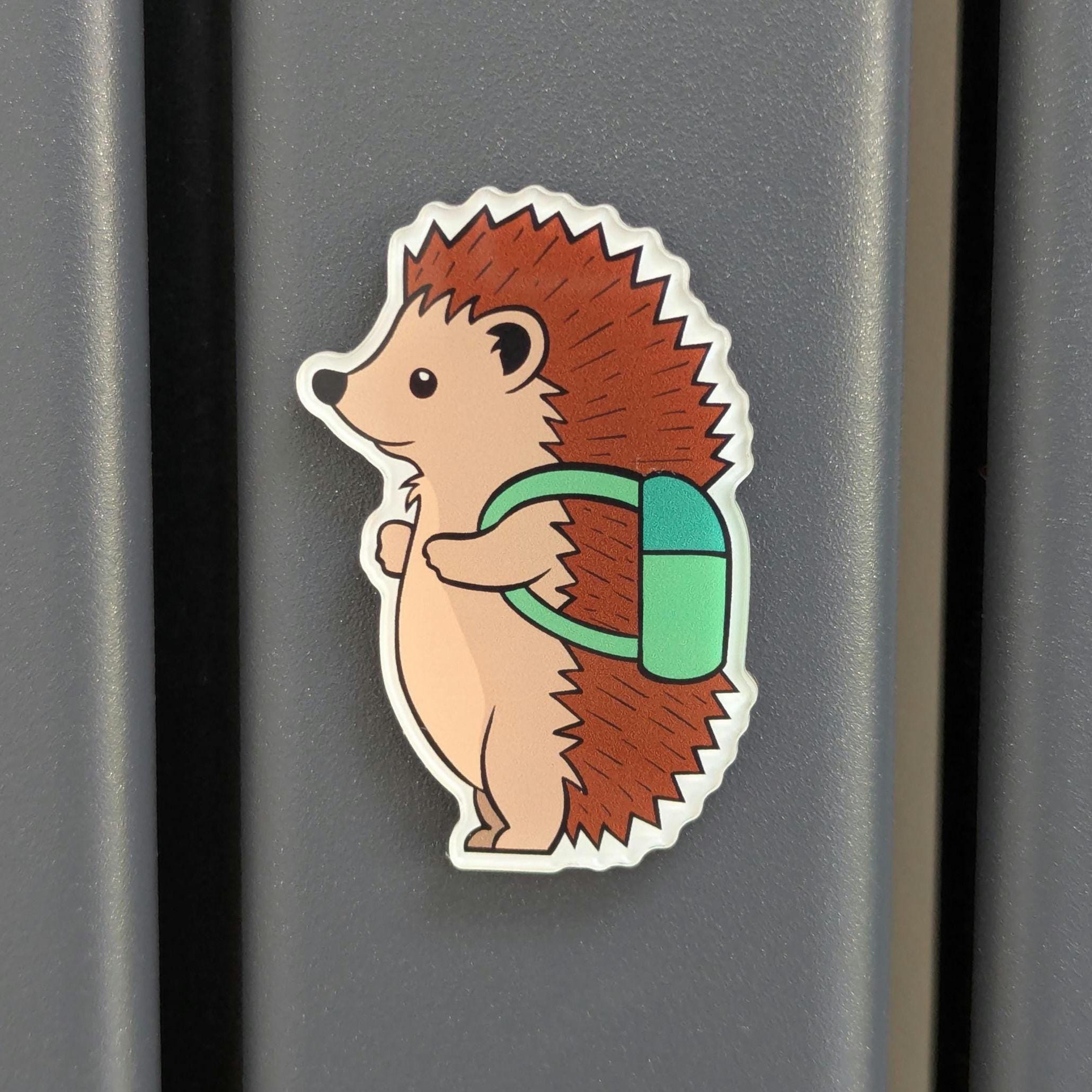 Cute hedgehog with a green backpack on a metallic surface