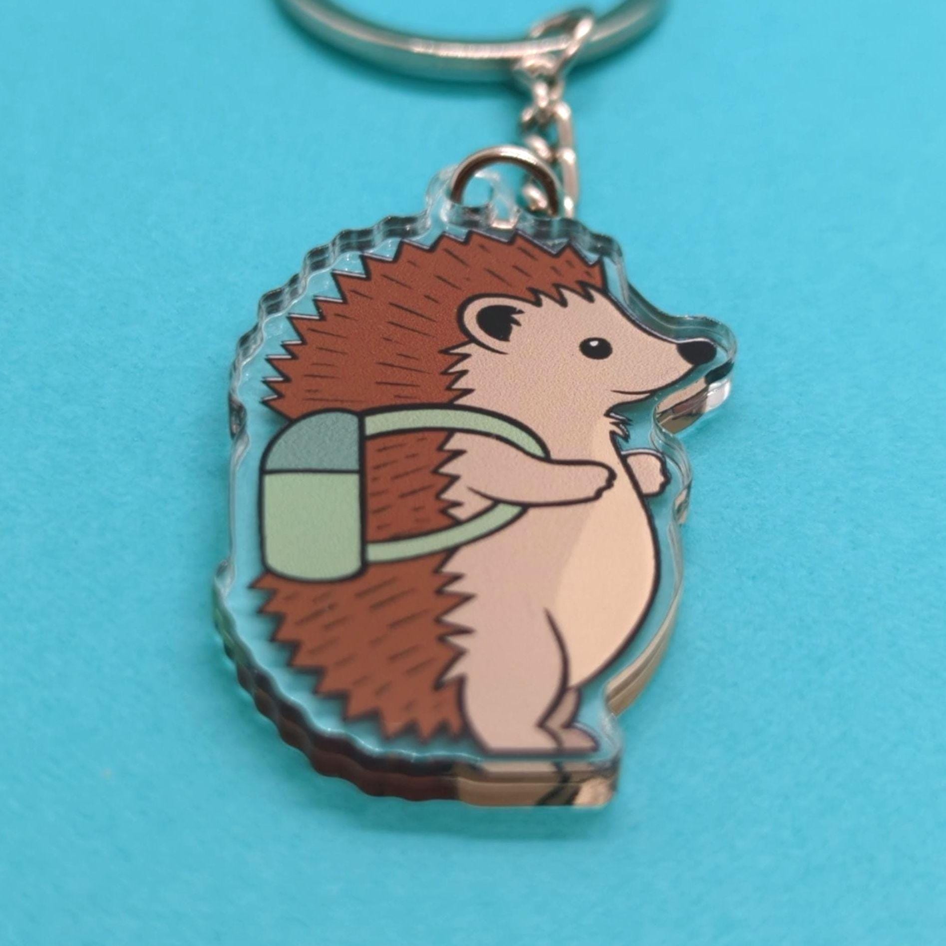 Keychain with a hedgehog design on a blue background