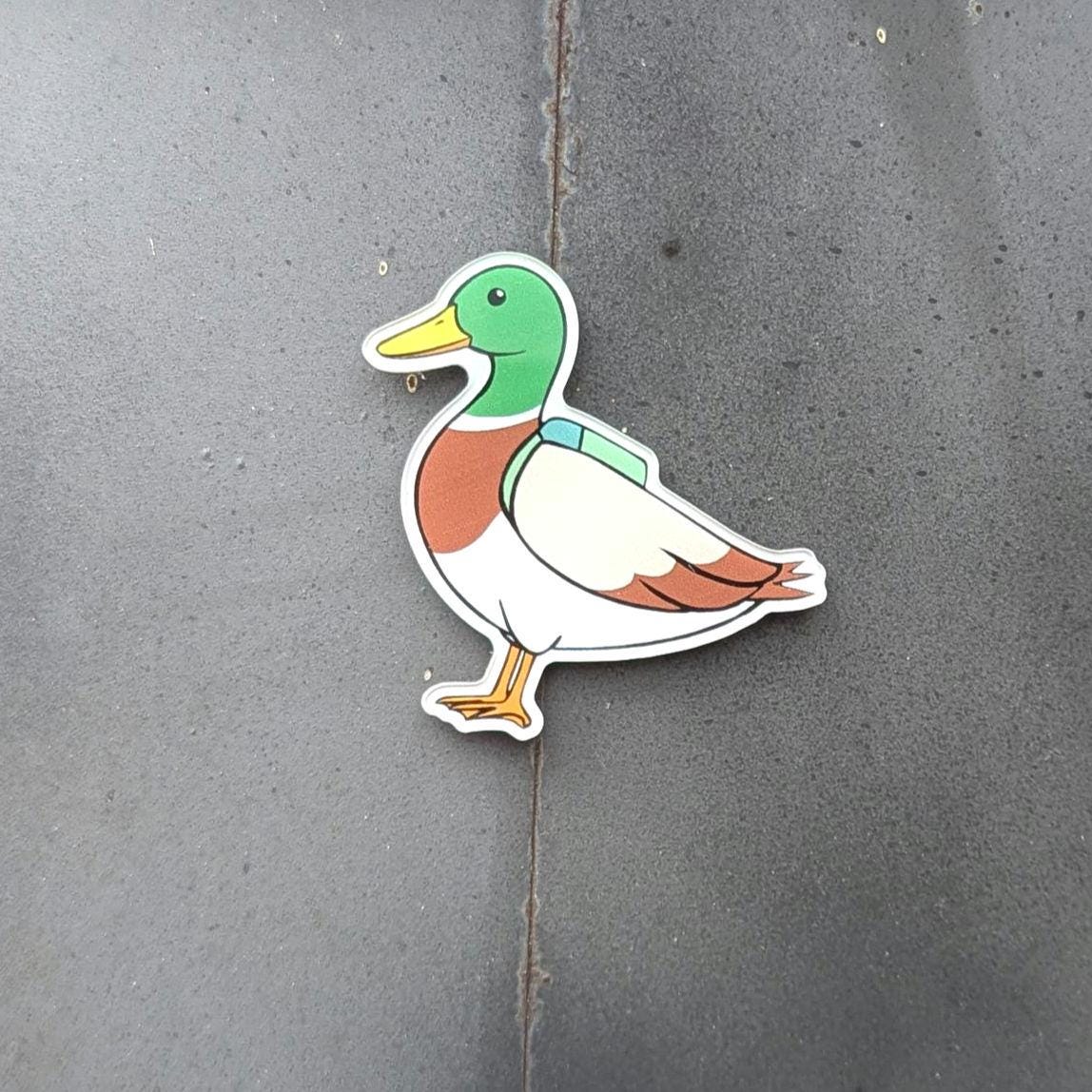 Duck fridge magnet on a concrete surface