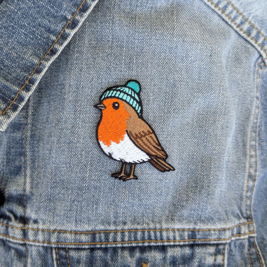 Embroidered robin patch on a denim jacket