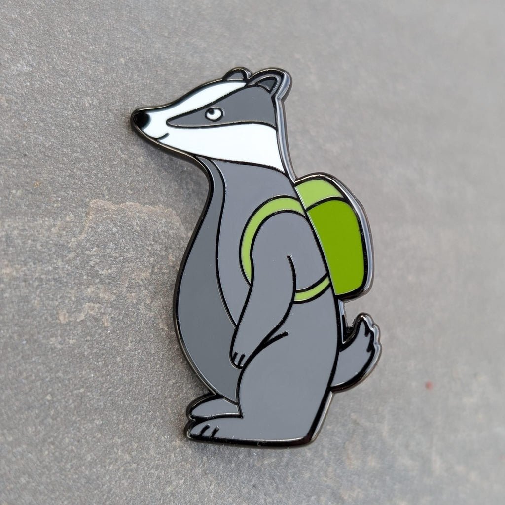 Badger with a green backpack on a gray background