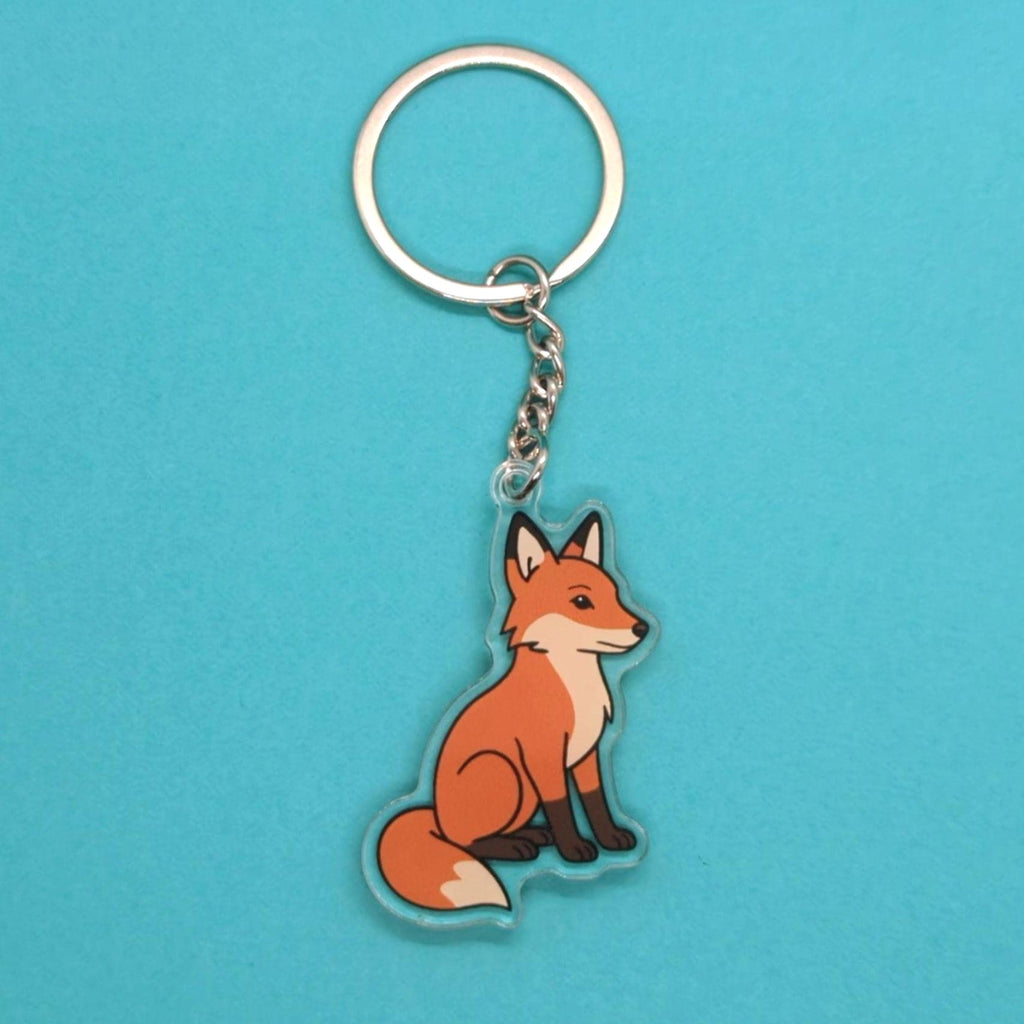 Fox keychain on a blue background