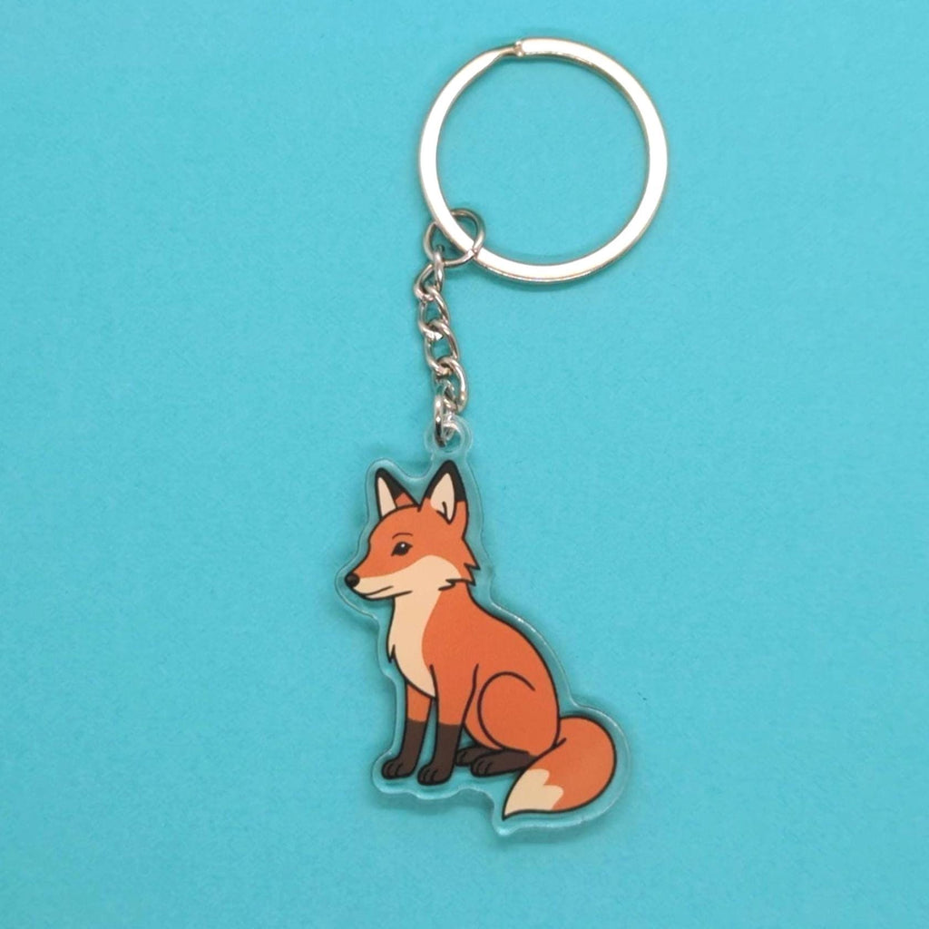 Red fox keychain on a blue background