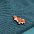 Fox wooden pin on a textured blue fabric background