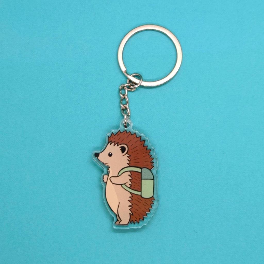 Hedgehog keychain with a backpack on a blue background