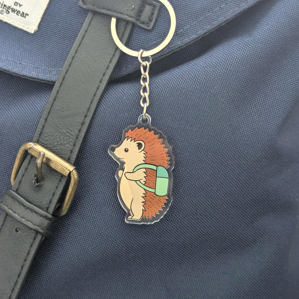 Hedgehog keychain with a backpack on a blue bag