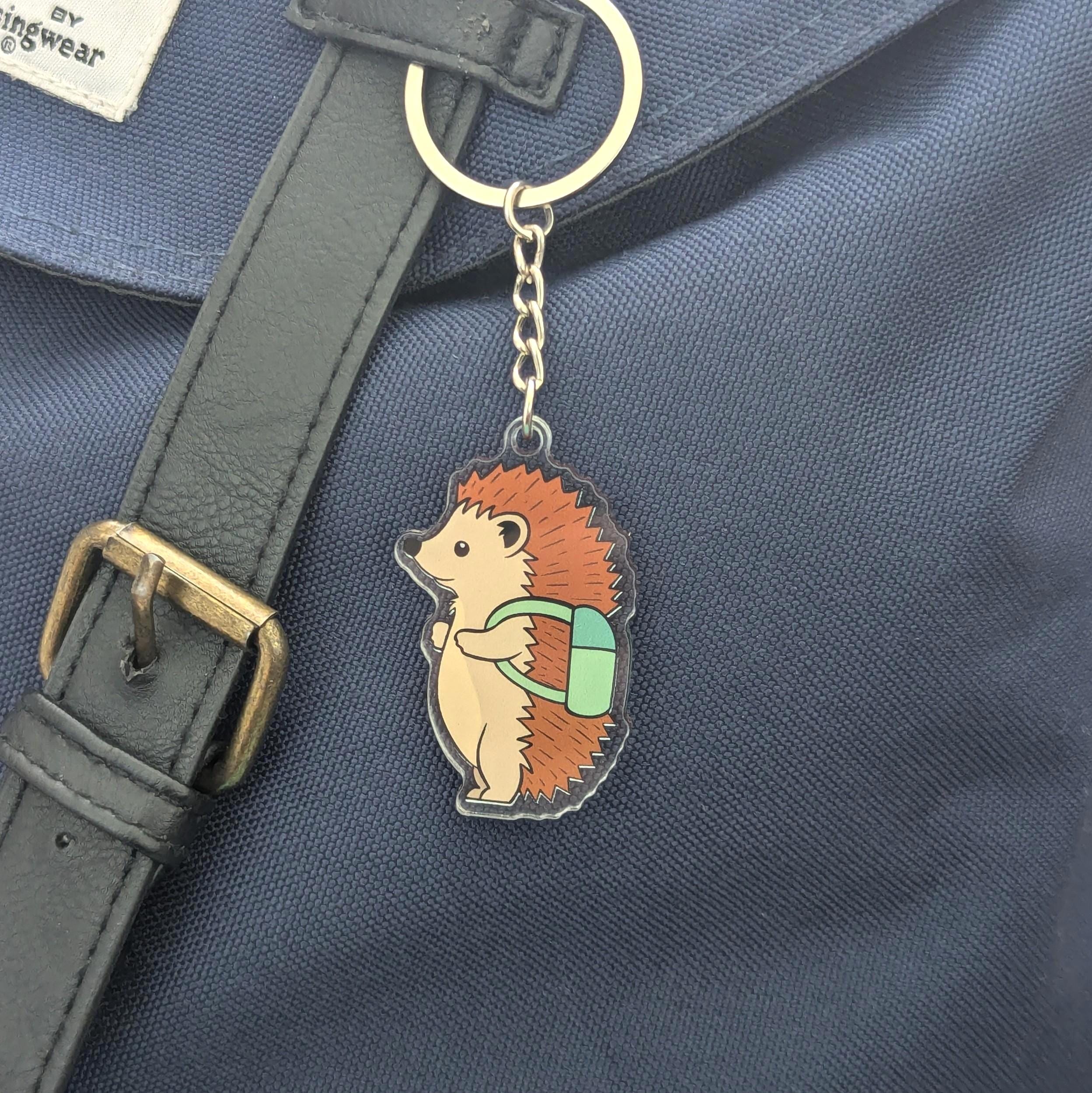 Hedgehog keychain with a backpack on a blue bag