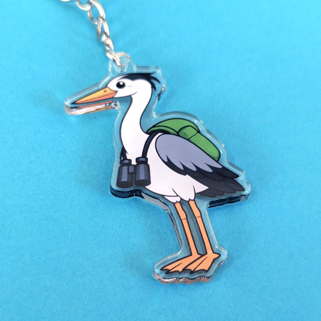 heron with backpack keychain on blue background by pin badger