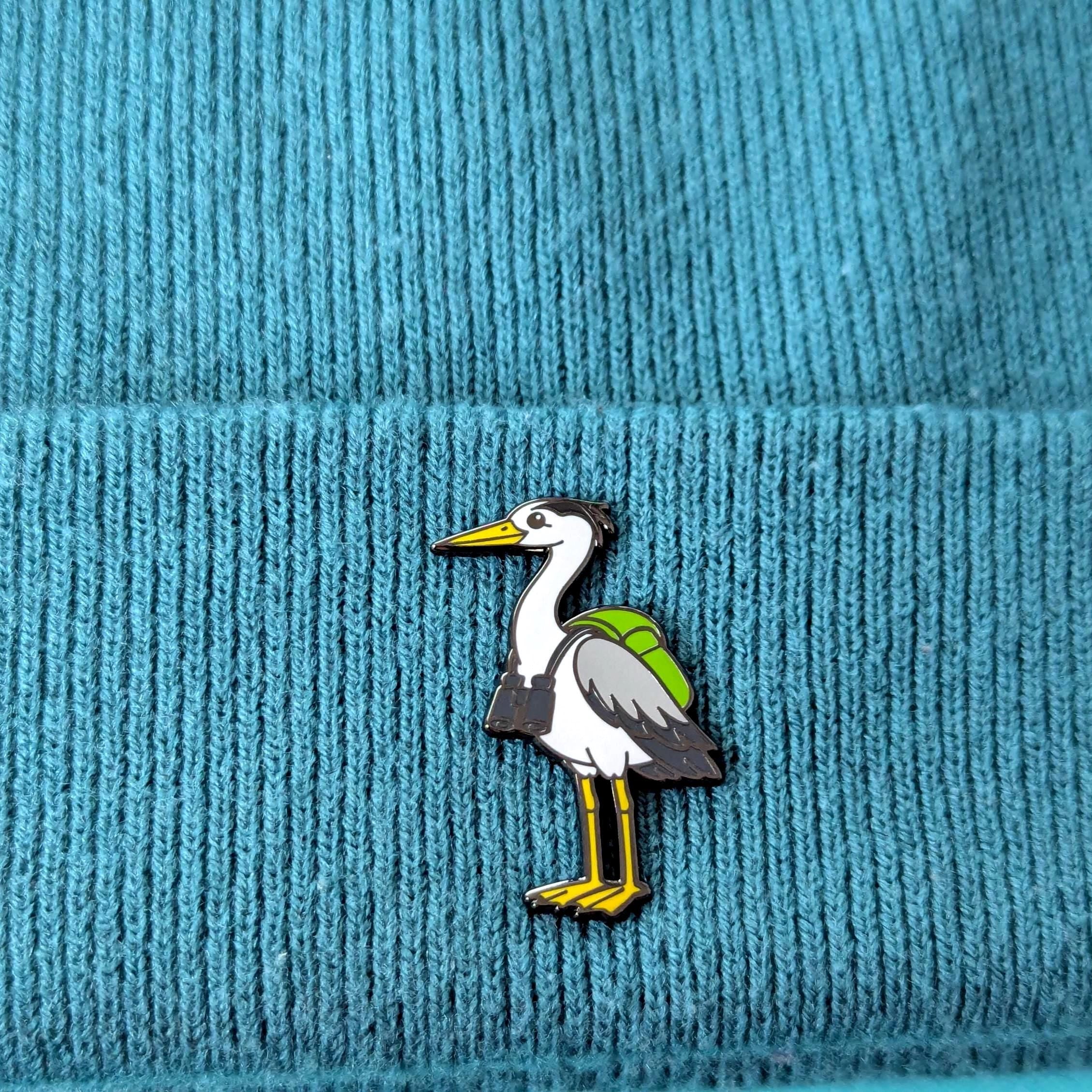 heron pin on a blue textured fabric background
