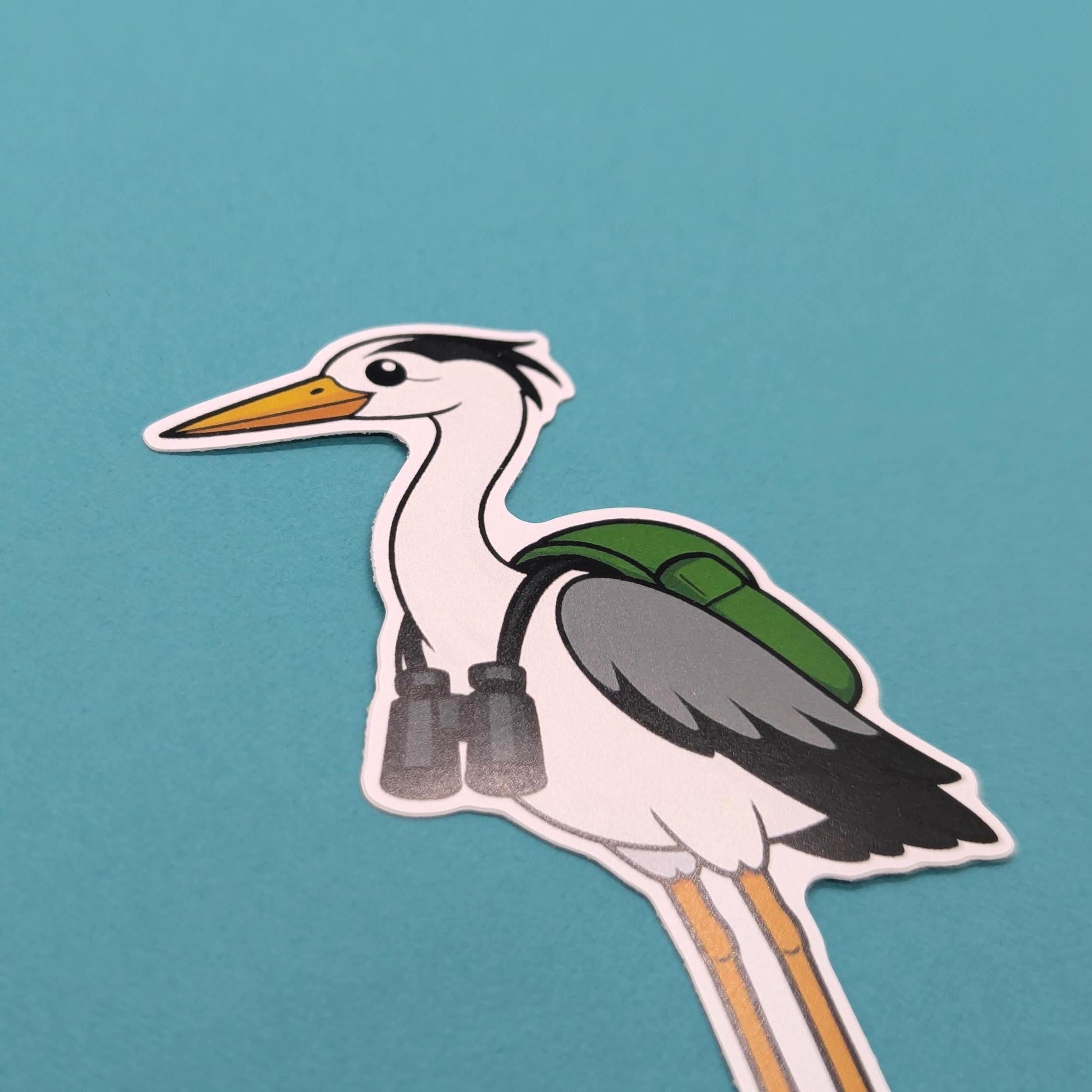 Cartoon heron with a green backpack and binoculars on a teal background