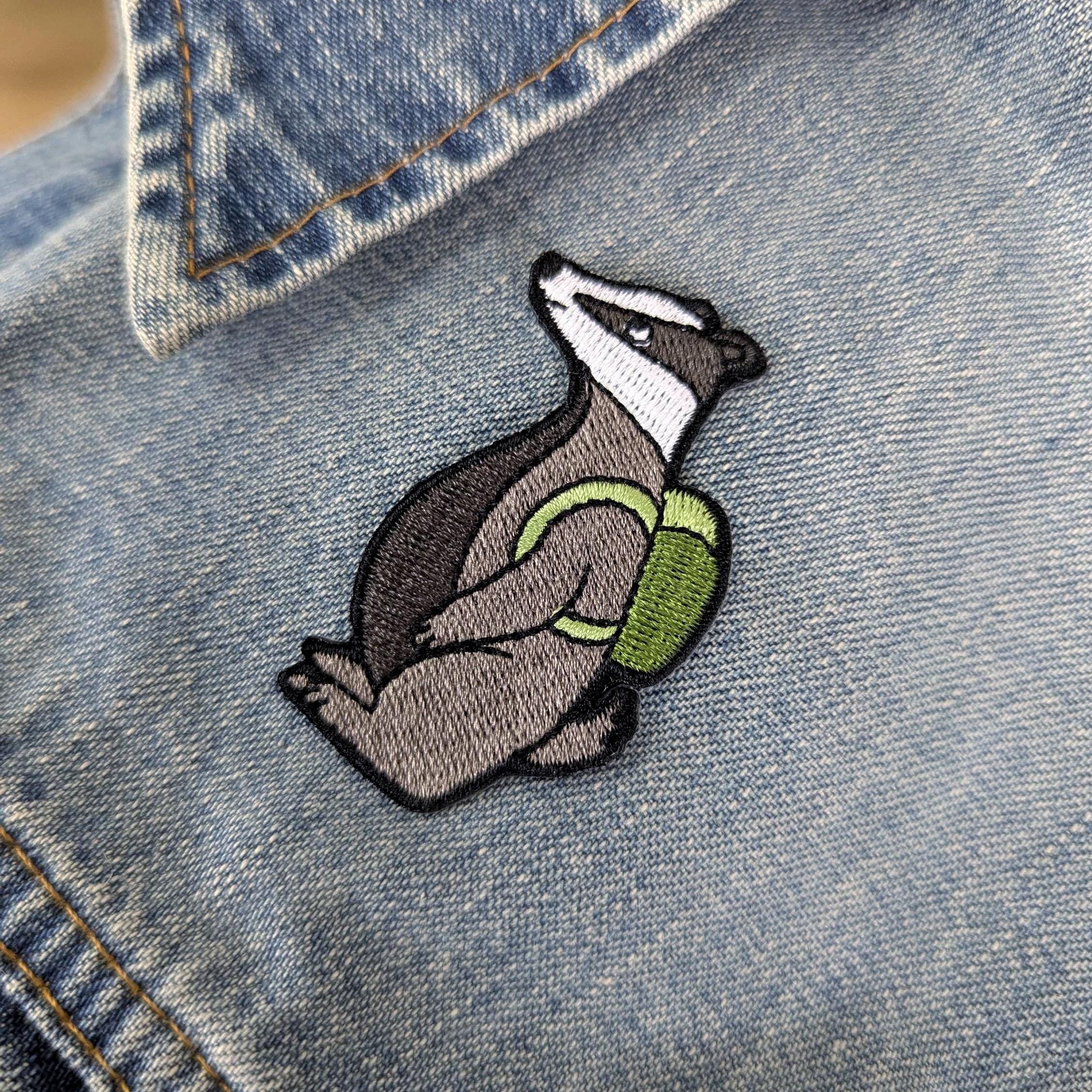 Embroidered badger patch on a denim jacket