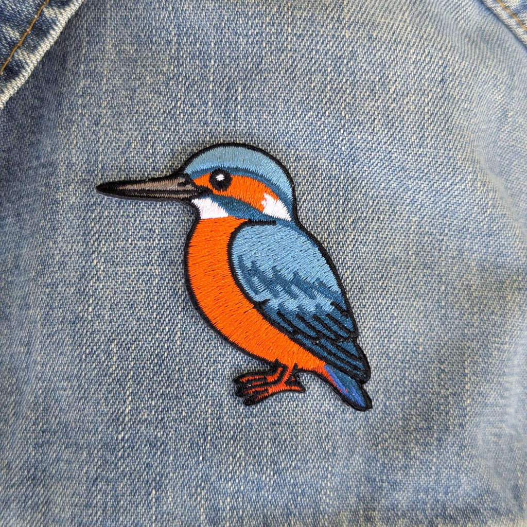 Kingfisher bird patch on a denim background