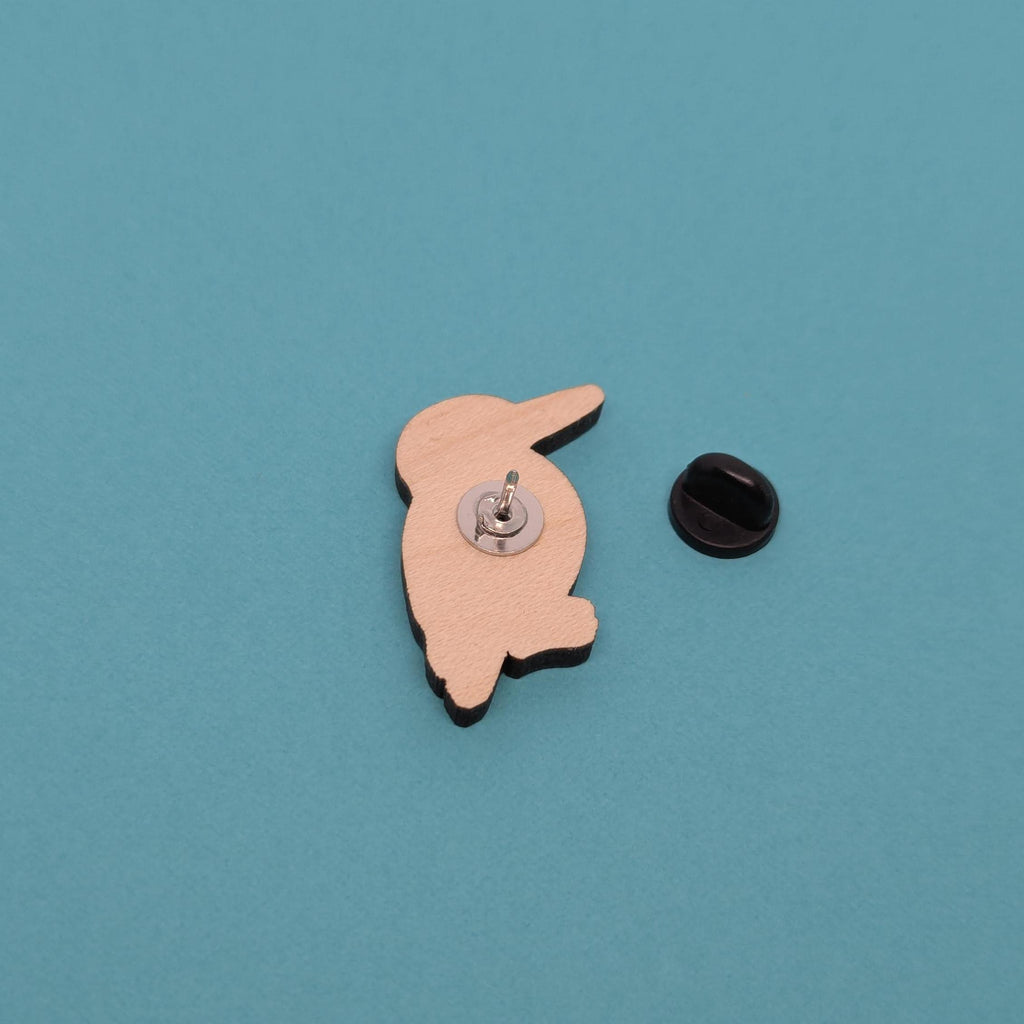 Kingfisher wooden pin with a unique design on a blue background