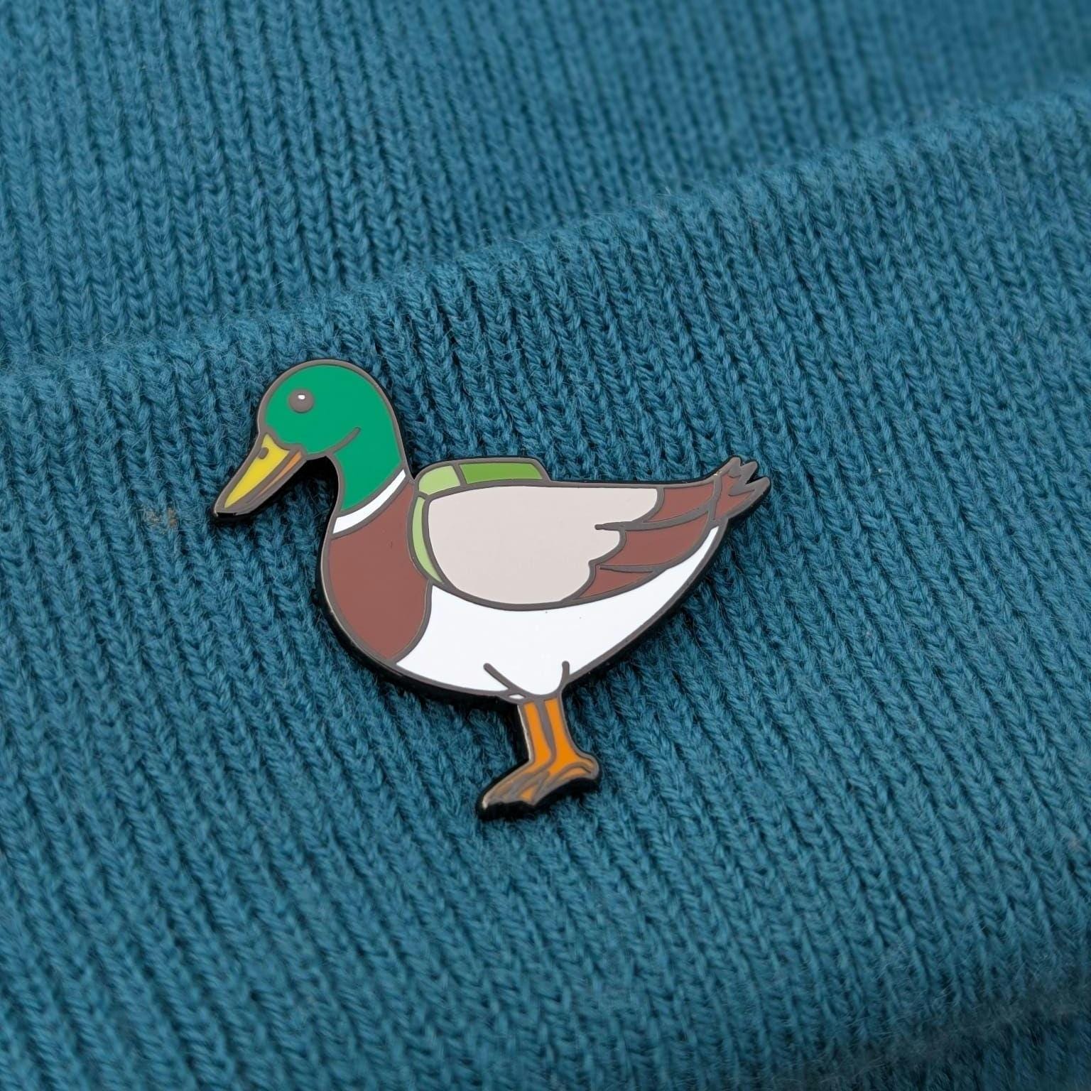 mallard duck pin on a textured blue background