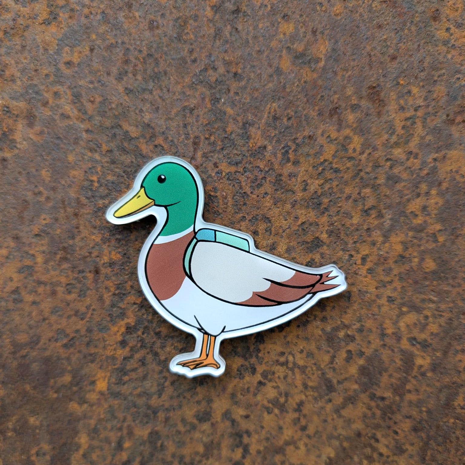 Colourful duck magnet on a rusty metal surface