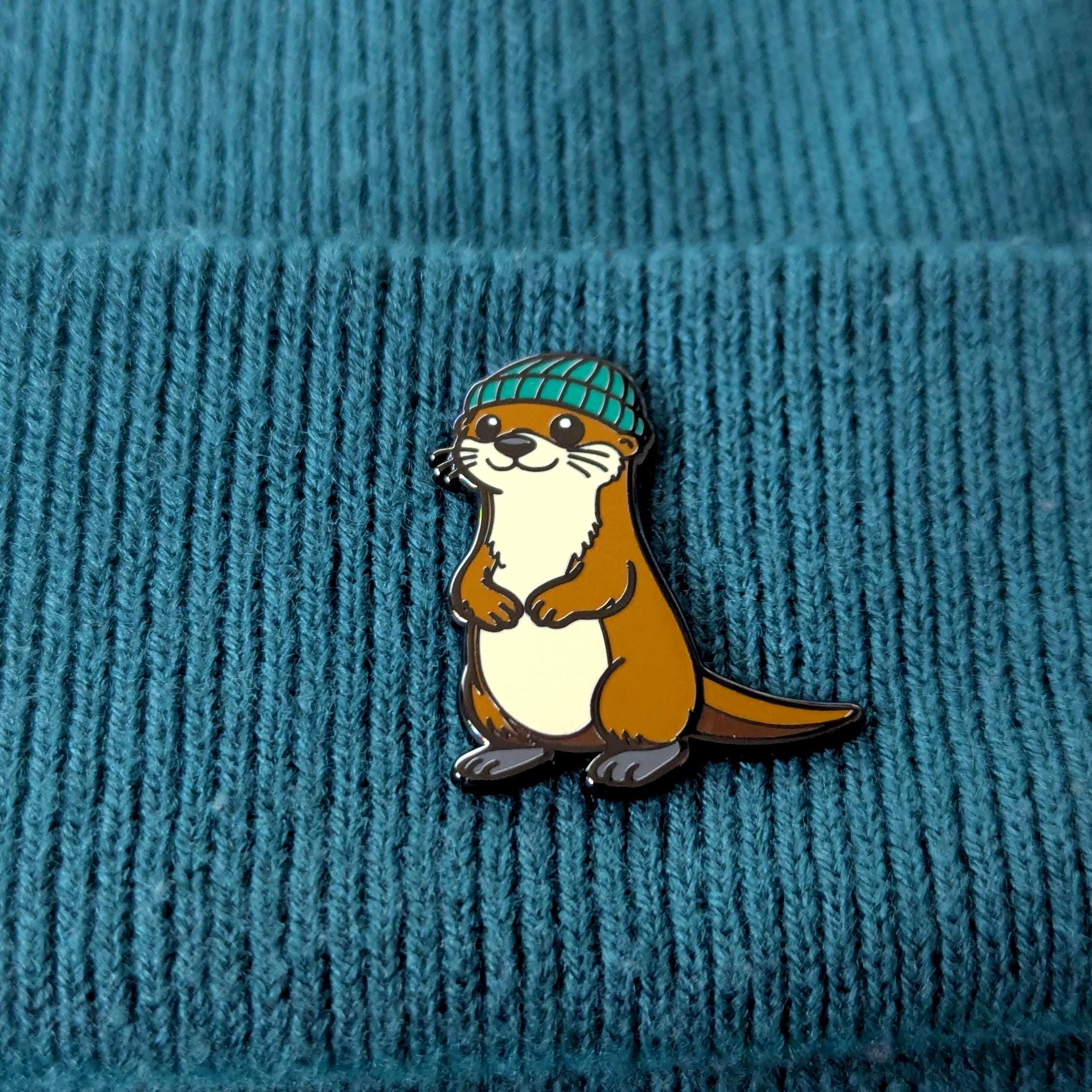 Otter wearing a green beanie on a textured blue background