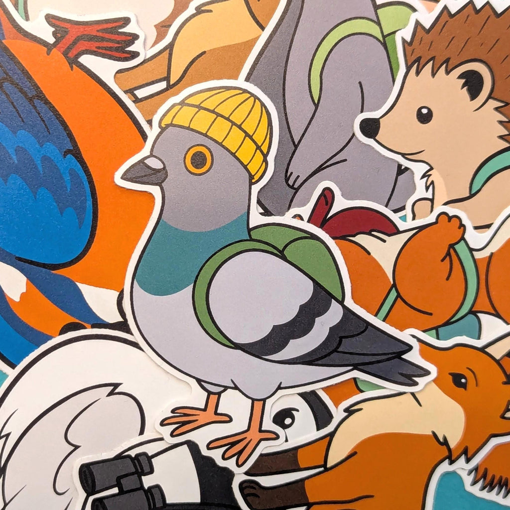 a die cut sticker of a pigeon wearing a beanie in front of many other pin badger animal stickers