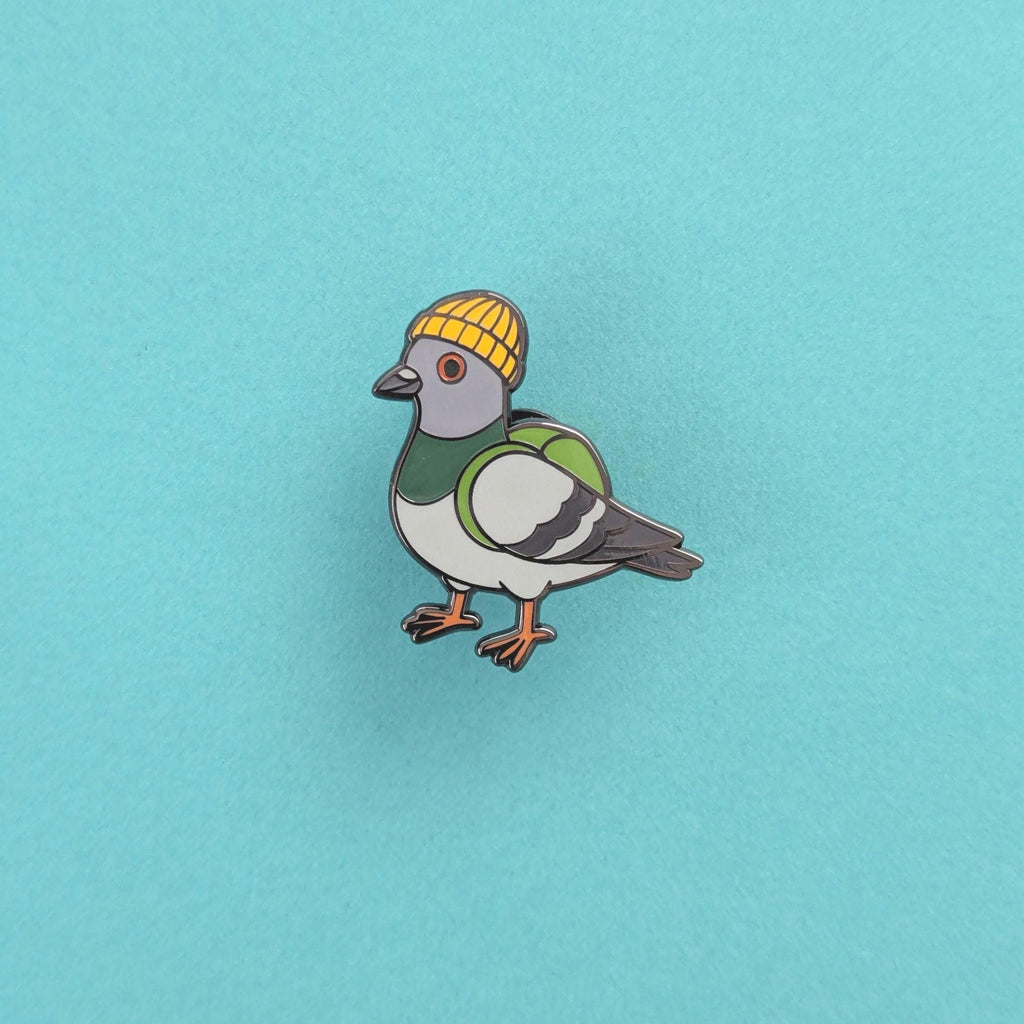 Pigeon wearing a yellow beanie on a light blue background