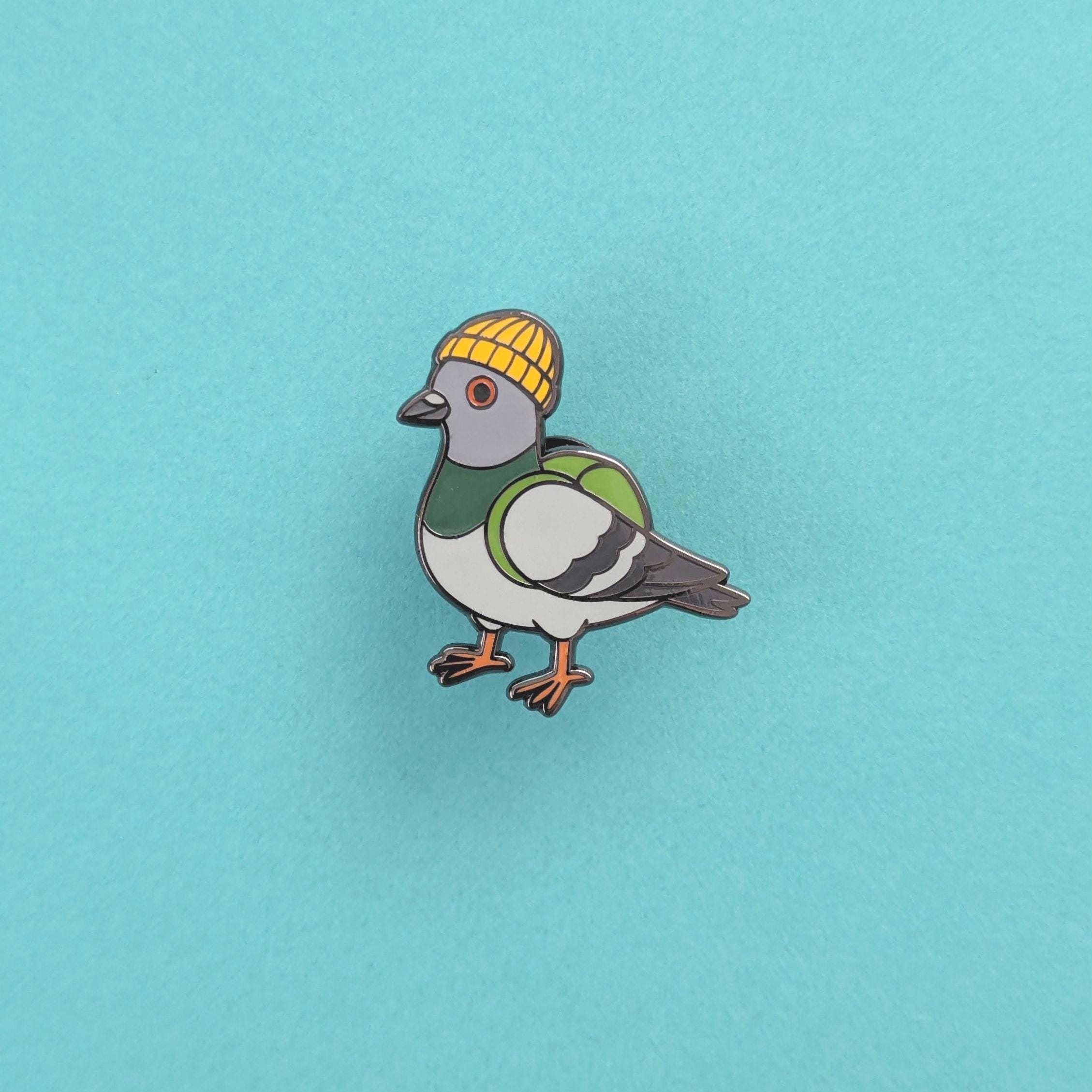 Pigeon wearing a yellow beanie on a light blue background