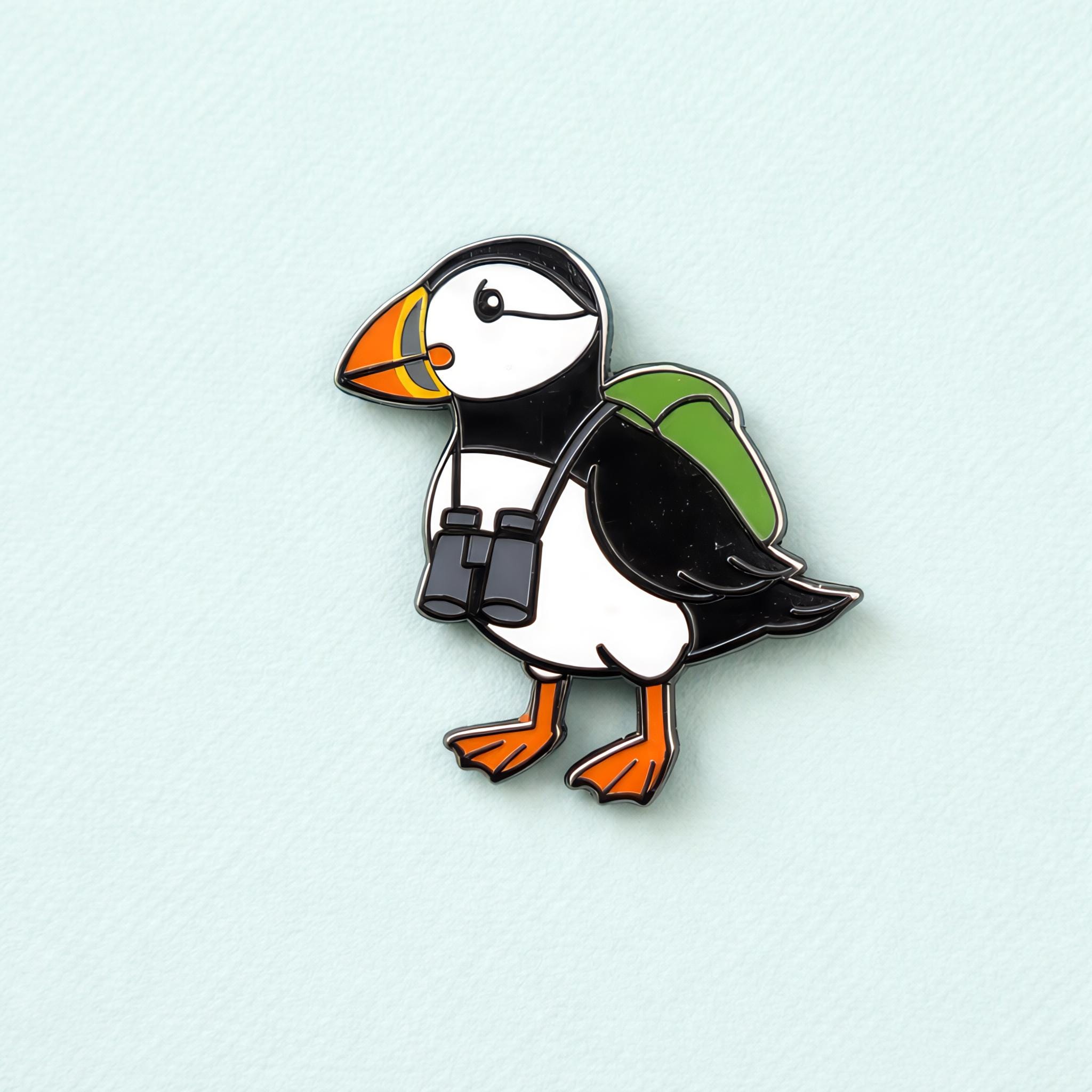 Puffin pin with a backpack on a light blue background