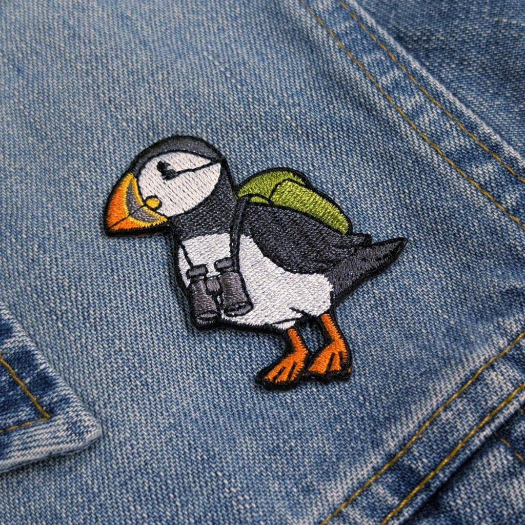 Embroidered puffin patch on a denim jacket