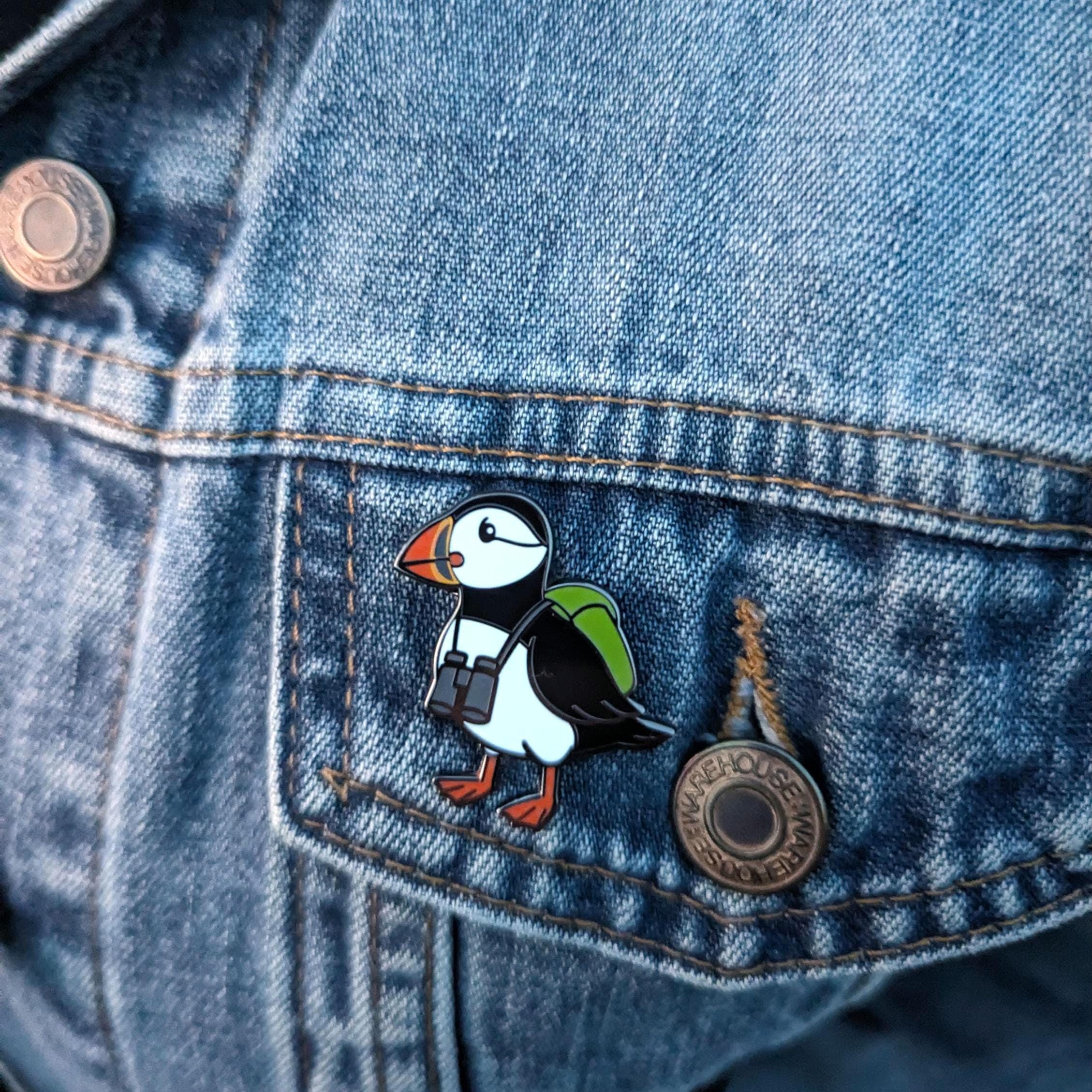Puffin-shaped pin on a denim jacket