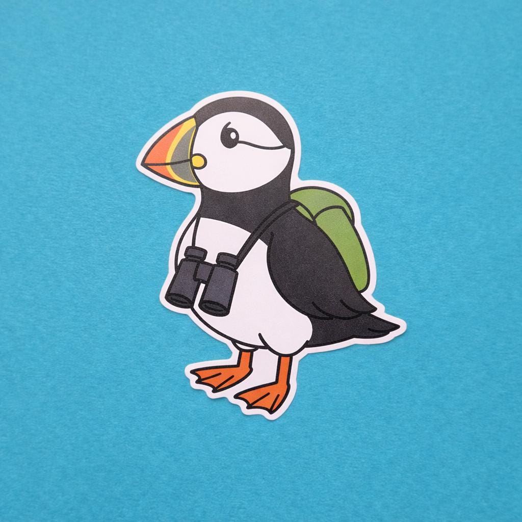 Sticker of a cartoon puffin with a backpack and binoculars on a blue background
