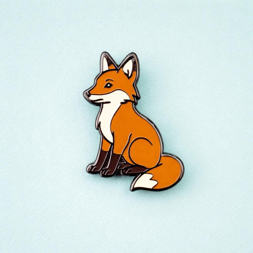 Fox-shaped pin on a light blue background