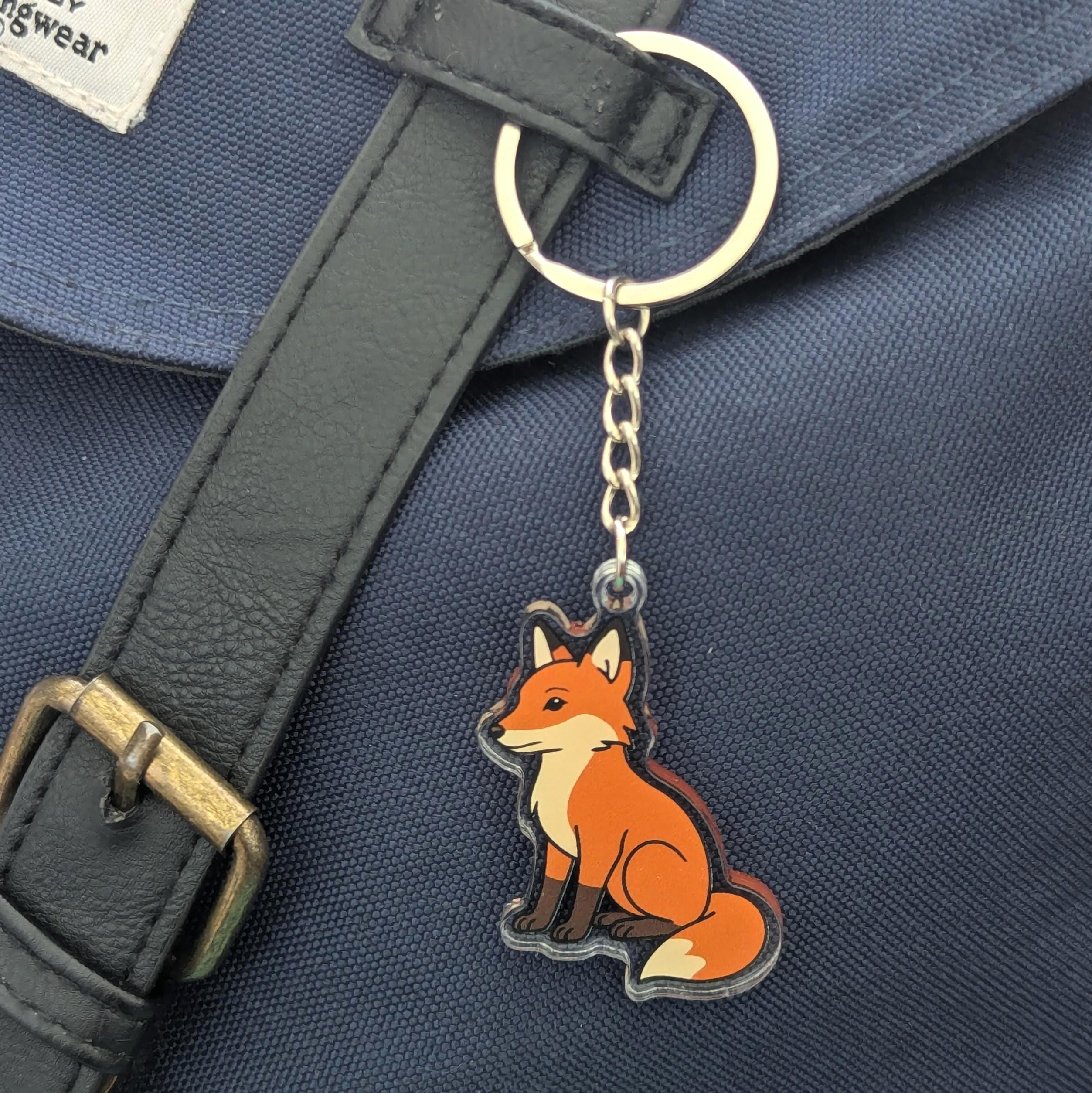 Fox keychain on a blue bag with a black strap